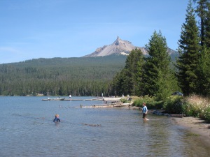 Lumberjacks in training: the boys found a floating log that they rolled around Diamond Lake.
